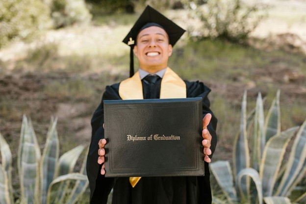 Newly Graduate Holding His Diploma